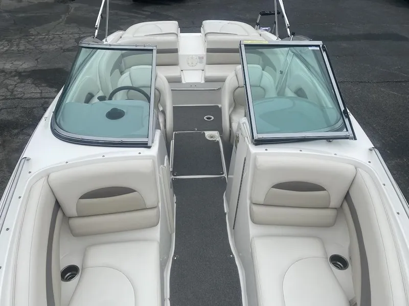 Slide: The Image of 2005 Chaparral 236 SSi boat interior with white seating and open windshield. - 7