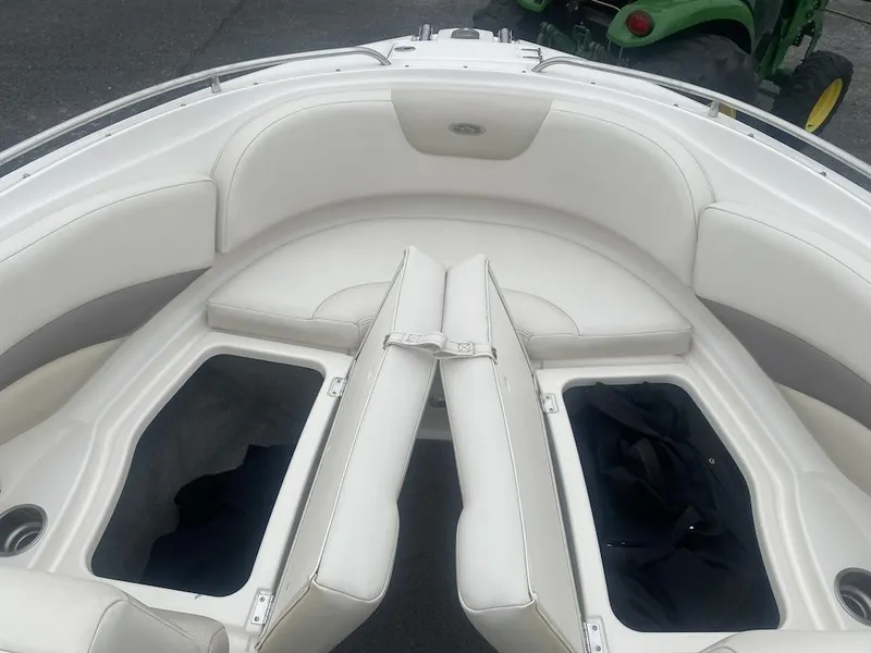 Slide: The Image of 2005 Chaparral 236 SSi boat interior with open storage compartments and white seating. - 9