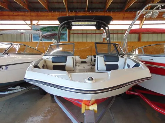 Slide: The Image of 2020 Yamaha Boats AR195 in a showroom, featuring sleek design and modern amenities. - 2