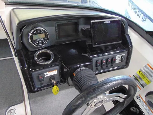 Slide: The Image of 2020 Yamaha AR195 boat dashboard with steering wheel, controls, and Simrad display. - 7