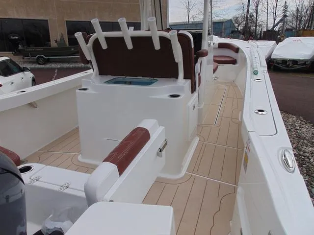 Slide: The Image of 2025 Parker 2400 Center Console boat interior with seating and rod holders. - 10