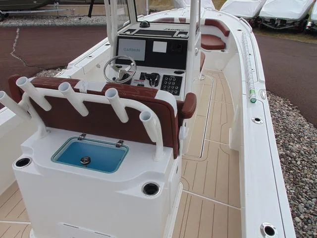 Slide: The Image of 2025 Parker 2400 Center Console boat with modern helm and rod holders. - 11