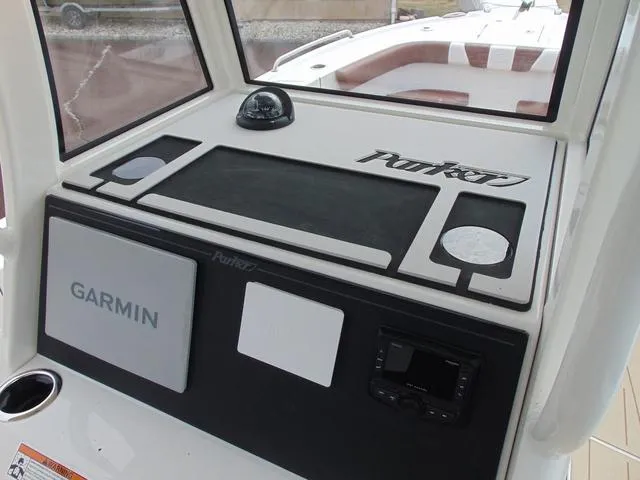 Slide: The Image of Center console of 2025 Parker 2400 boat with Garmin navigation system. - 15