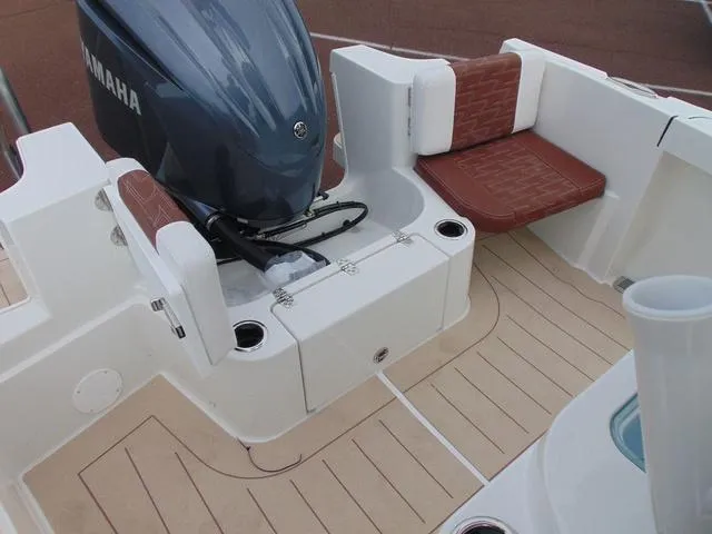 Slide: The Image of 2025 Parker 2400 Center Console boat interior with Yamaha engine and cushioned seating. - 17