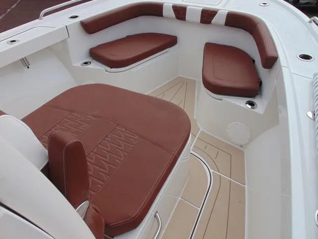 Slide: The Image of 2025 Parker 2400 Center Console boat interior with brown cushioned seating and white accents. - 18