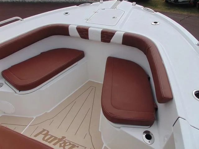 Slide: The Image of 2025 Parker 2400 Center Console boat interior with brown cushioned seating. - 19