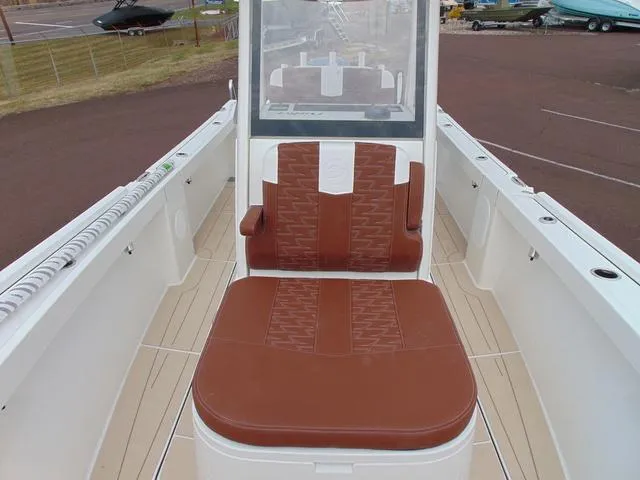 Slide: The Image of 2025 Parker 2400 Center Console boat with brown seating and sleek design. - 20