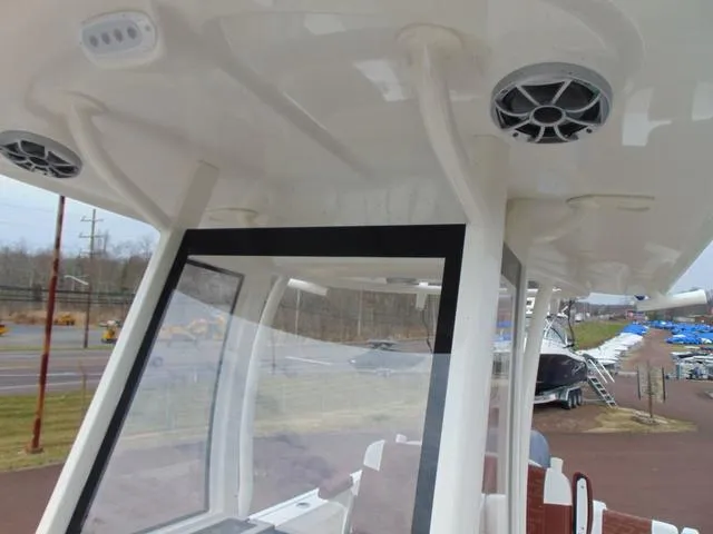 Slide: The Image of 2025 Parker 2400 Center Console boat interior with speakers and windshield. - 23