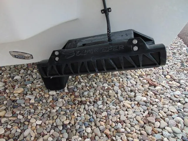 Slide: The Image of Transom-mounted trim tab on Parker 2400 Center Console 2025, resting on pebbled ground. - 27