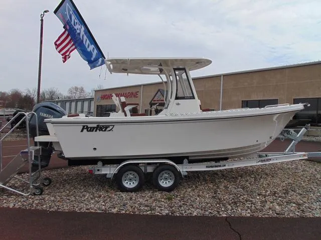 Slide: The Image of 2025 Parker 2400 Center Console boat on trailer, displayed outdoors with flags. - 4