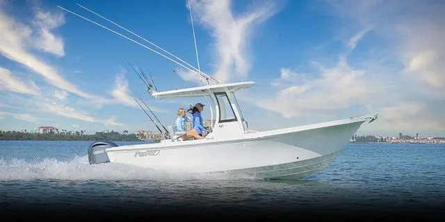 Slide: The Image of 2025 Parker 2400 Center Console boat cruising on a sunny day with two passengers. - 8