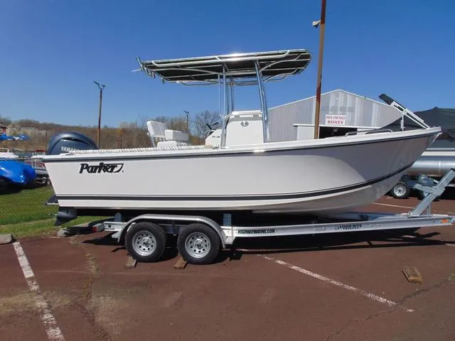 The Image of 2025 Parker 21SE Center Console boat on trailer, displayed outdoors under clear blue sky. - 1