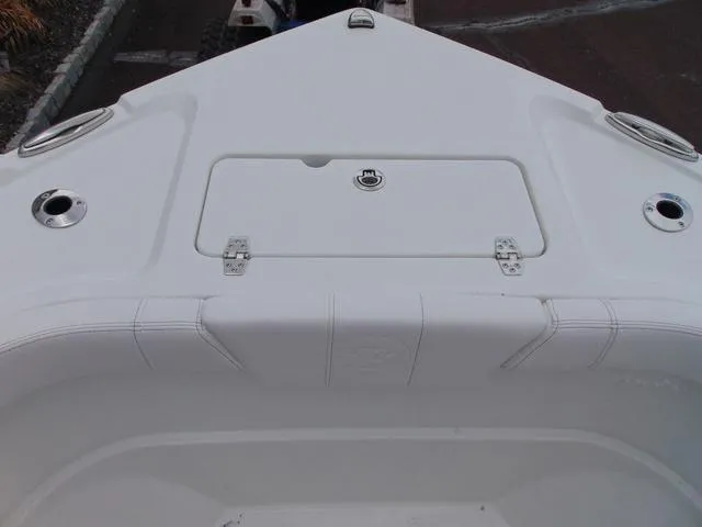 Slide: The Image of 2025 Parker 21SE Center Console boat deck with storage compartment and cup holders. - 10