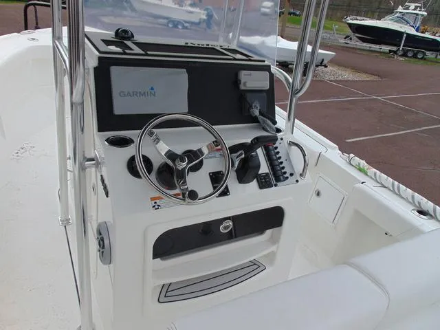 Slide: The Image of 2025 Parker 21SE Center Console boat with Garmin navigation system, steering wheel, and control panel. - 6