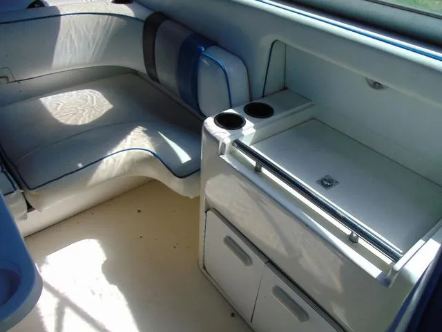 Slide: The Image of Interior of 1990 Sea Ray 260 Overnighter boat with seating and storage area. - 13