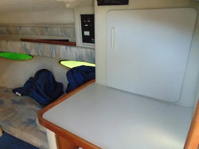 Slide: The Image of Interior cabin of a 1990 Sea Ray 260 Overnighter boat, featuring seating and storage. - 16