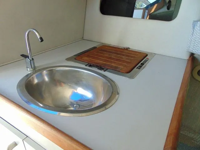 Slide: The Image of 1990 Sea Ray 260 Overnighter boat kitchenette with sink and stove. - 18