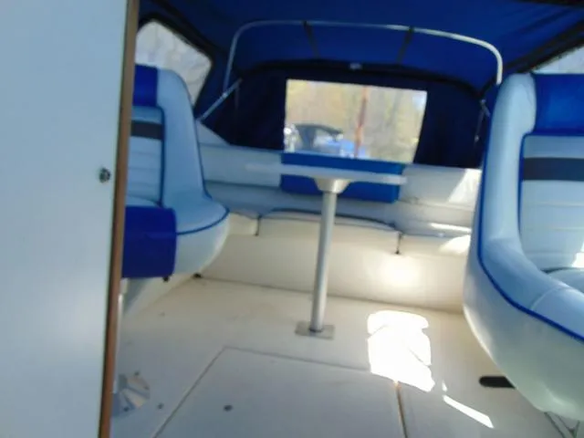 Slide: The Image of Interior of 1990 Sea Ray 260 Overnighter boat with blue and white seating. - 26