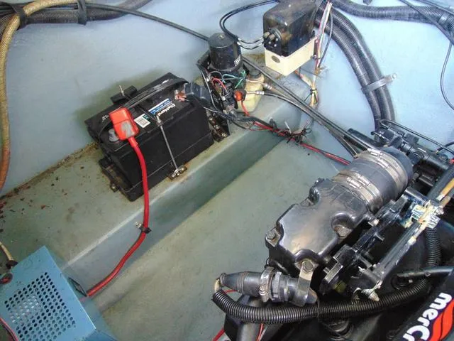 Slide: The Image of Engine compartment of a 1990 Sea Ray 260 Overnighter with battery and wiring. - 30