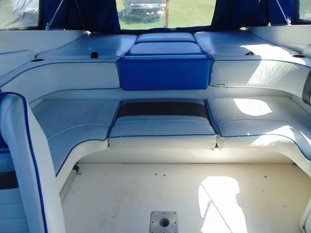 Slide: The Image of 1990 Sea Ray 260 Overnighter boat interior with blue and white seating. - 7