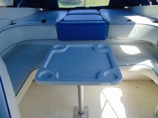 Slide: The Image of Interior of a 1990 Sea Ray 260 Overnighter boat with seating and table. - 8