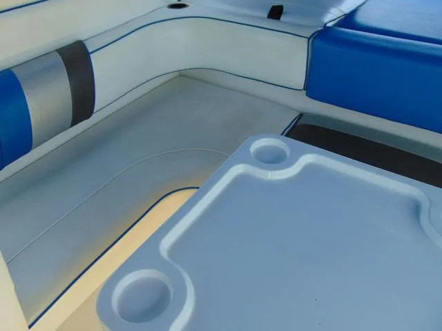 Slide: The Image of Interior seating of 1990 Sea Ray 260 Overnighter with blue and gray upholstery. - 9