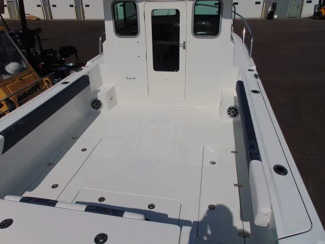 Slide: The Image of 2025 Parker 2420 Sport Cabin boat interior, spacious deck, white finish, modern design. - 10