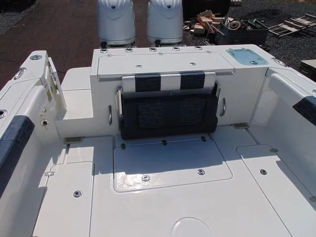 Slide: The Image of 2025 Parker 2420 Sport Cabin boat deck with seating and dual engines. - 15