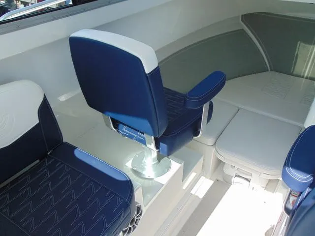 Slide: The Image of 2025 Parker 2420 Sport Cabin interior with blue and white seating, showcasing modern design. - 17