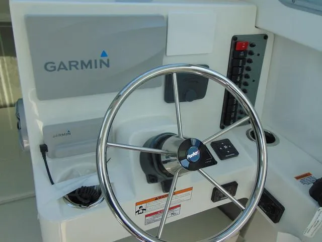 Slide: The Image of Steering wheel and Garmin system on 2025 Parker 2420 Sport Cabin boat. - 21
