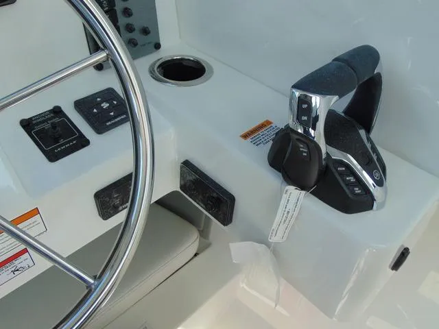Slide: The Image of Control panel of 2025 Parker 2420 Sport Cabin boat with steering wheel and throttle. - 22