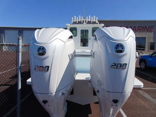 Slide: The Image of 2025 Parker 2420 Sport Cabin with dual Yamaha 200 engines, parked outdoors. - 5