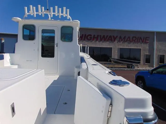 Slide: The Image of 2025 Parker 2420 Sport Cabin boat at Highway Marine dealership. - 6