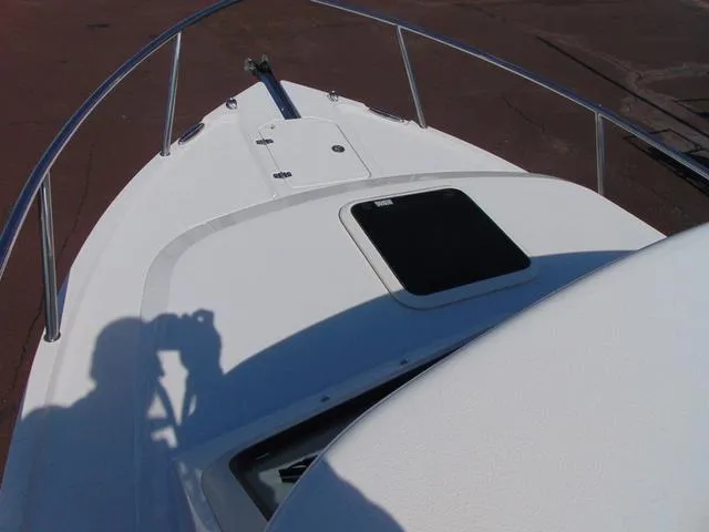 Slide: The Image of 2025 Parker 2420 Sport Cabin boat deck with railing and hatch. - 7