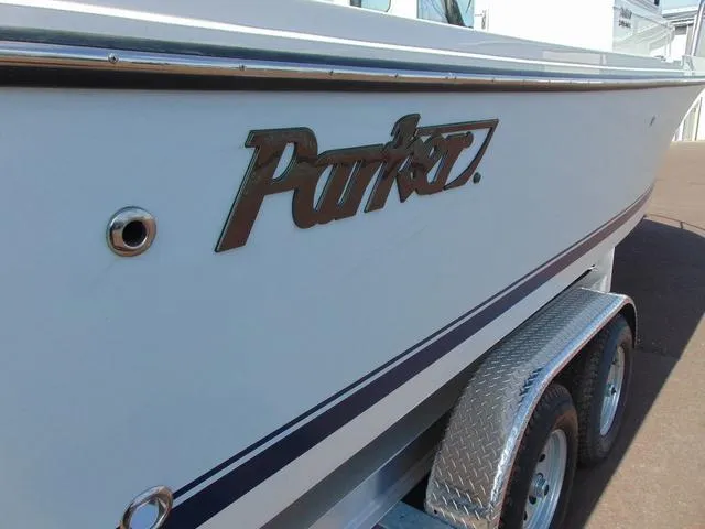 Slide: The Image of 2025 Parker 2420 Sport Cabin boat on trailer, side view with logo. - 8