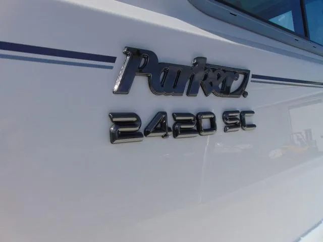 Slide: The Image of Parker 2420 Sport Cabin 2025 boat logo on white hull. - 9