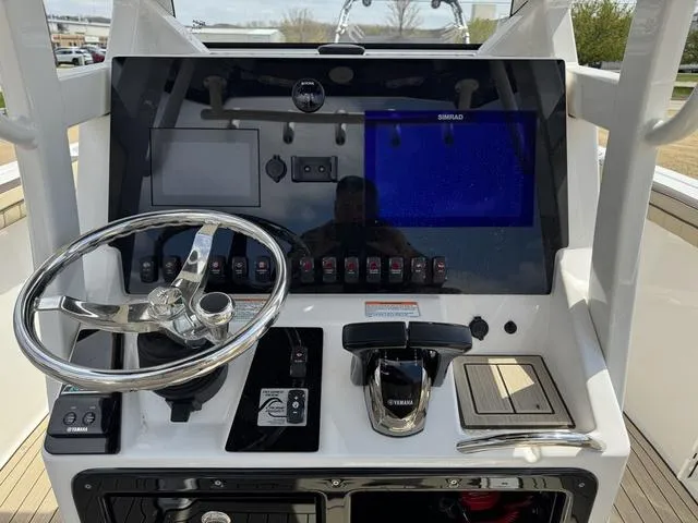 Slide: The Image of 2022 Yamaha Boats 255 FSH® SPORT E dashboard with steering wheel and controls. - 10