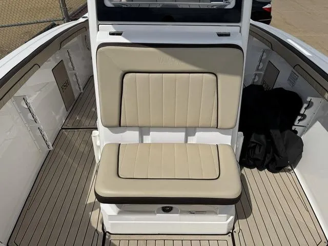 Slide: The Image of 2022 Yamaha Boats 255 FSH® SPORT E interior with beige seating and sleek design. - 11