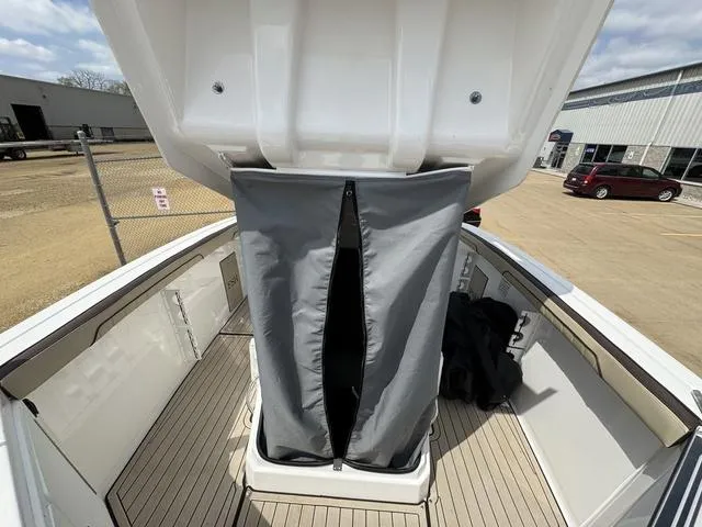 Slide: The Image of 2022 Yamaha Boats 255 FSH® SPORT E interior with open storage compartment. - 12