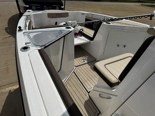 Slide: The Image of 2022 Yamaha Boats 255 FSH® SPORT E interior with seating and deck view. - 13