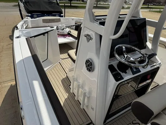 Slide: The Image of 2022 Yamaha Boats 255 FSH® SPORT E interior with steering console and seating. - 17