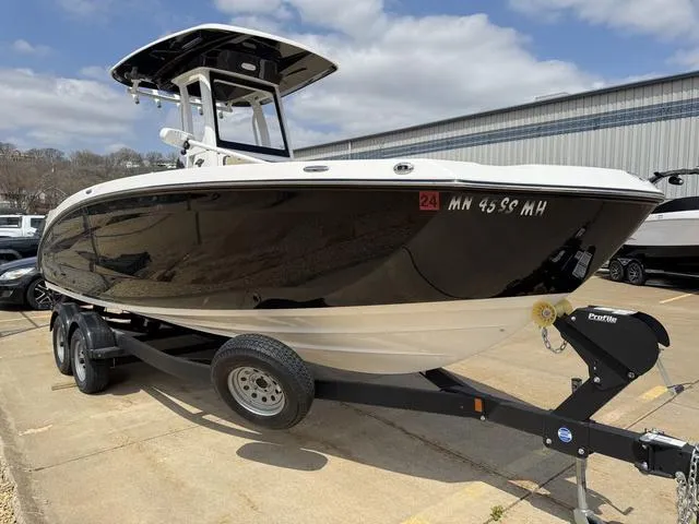 Slide: The Image of 2022 Yamaha Boats 255 FSH® SPORT E on trailer, parked outdoors. - 2