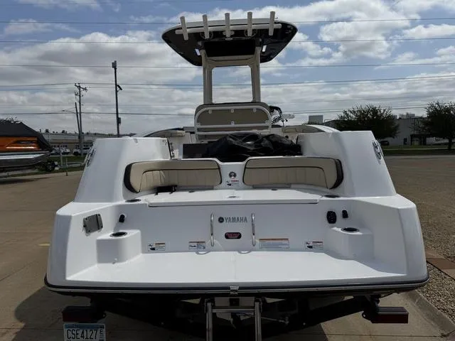 Slide: The Image of 2022 Yamaha Boats 255 FSH® SPORT E, rear view, docked under cloudy sky. - 4