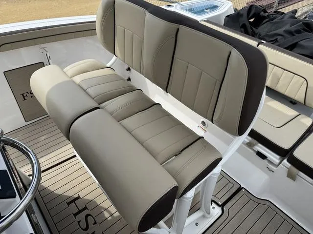 Slide: The Image of 2022 Yamaha Boats 255 FSH® SPORT E interior seating with beige upholstery. - 8
