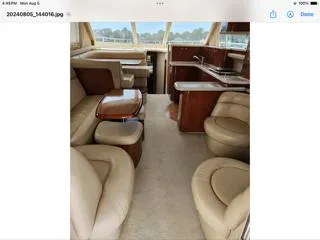Slide: The Image of Luxurious interior of 2004 Sea Ray 480 Sedan Bridge yacht with leather seating and wooden accents. - 12