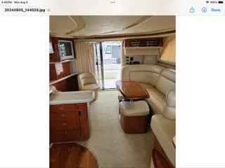 Slide: The Image of Luxurious interior of a 2004 Sea Ray 480 Sedan Bridge yacht with elegant seating and wood finishes. - 13