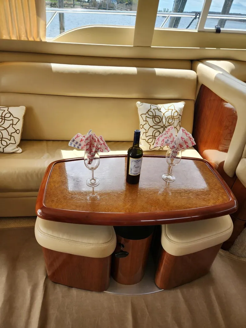 Slide: The Image of Luxurious interior of 2004 Sea Ray 480 Sedan Bridge with elegant table setting. - 14