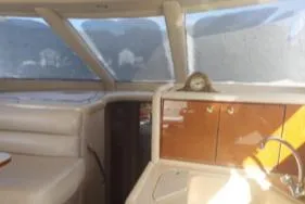 Slide: The Image of Interior of 2004 Sea Ray 480 Sedan Bridge yacht with beige seating and wooden cabinetry. - 16