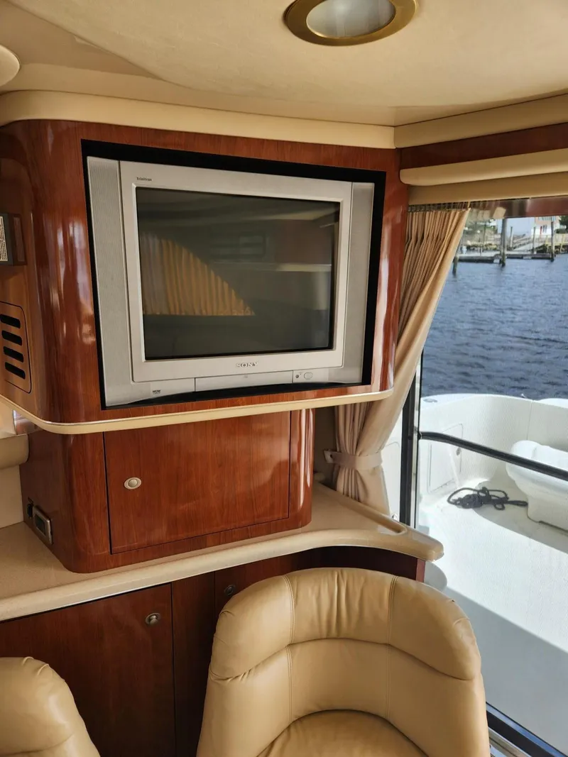Slide: The Image of Interior of 2004 Sea Ray 480 Sedan Bridge with TV and leather seating. - 20