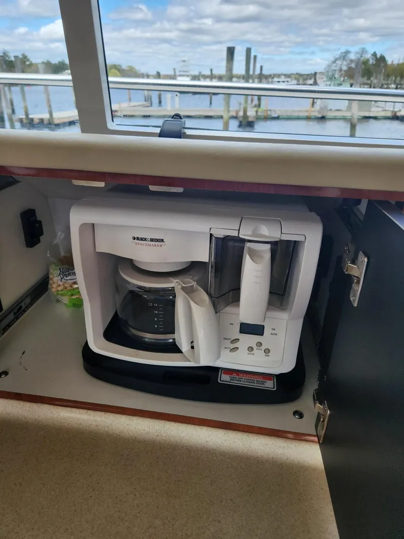Slide: The Image of Coffee maker in a 2004 Sea Ray 480 Sedan Bridge yacht kitchen, with marina view. - 27